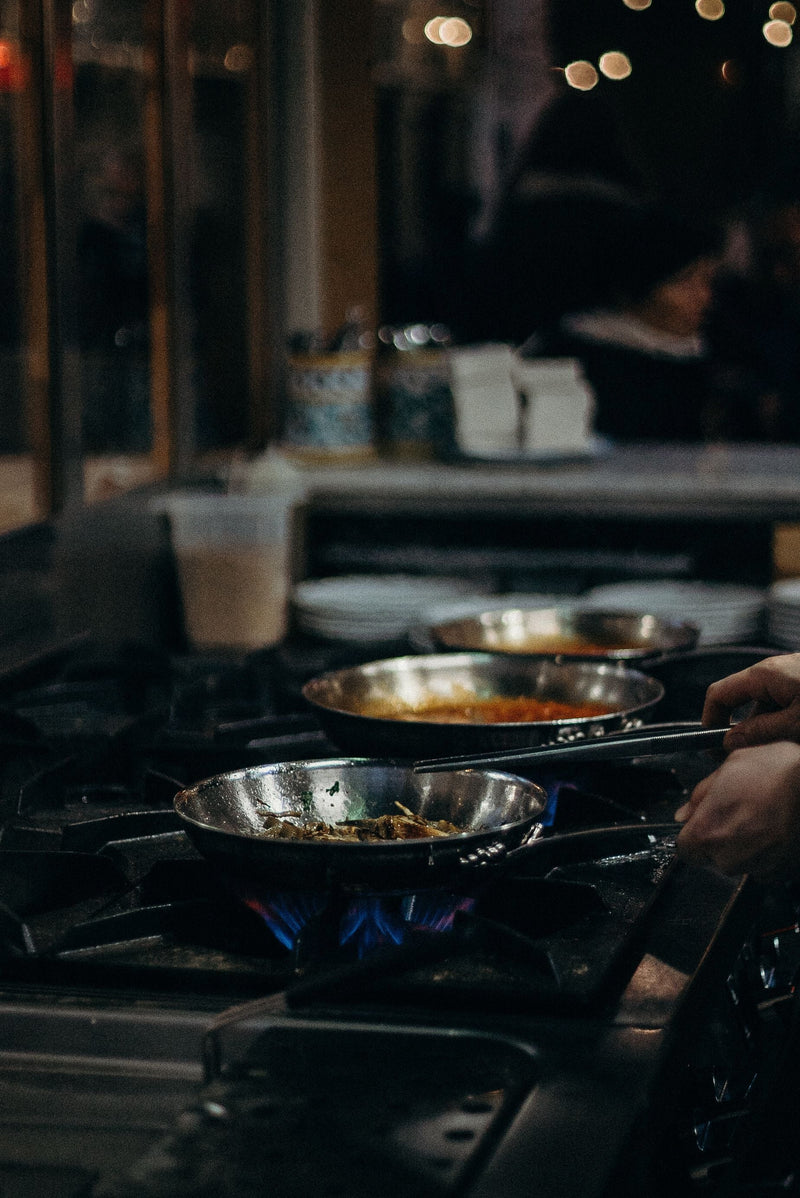 What Is Tri-Ply Cookware, and Why Do Chefs Swear By It? Cross-section of a tri-ply stainless steel kadai showing its three bonded layers
